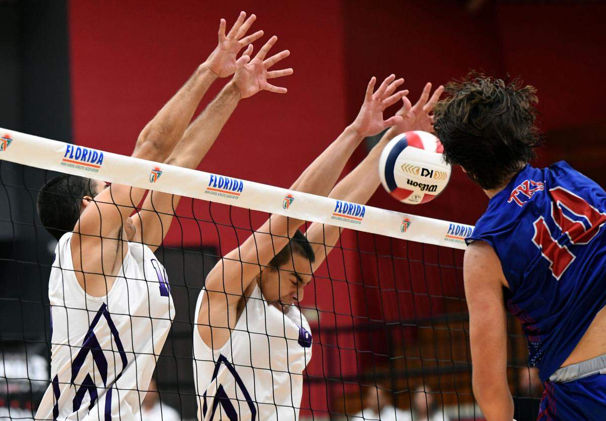 Miami Southwest front-line players Mitchell Deleon (left) and Carlos Gancedo (right) block a shot from The Kings Academy during a semifinal at the FHSAA boys volleyball state championships Saturday at Polk State College in Winter Haven, Fla.