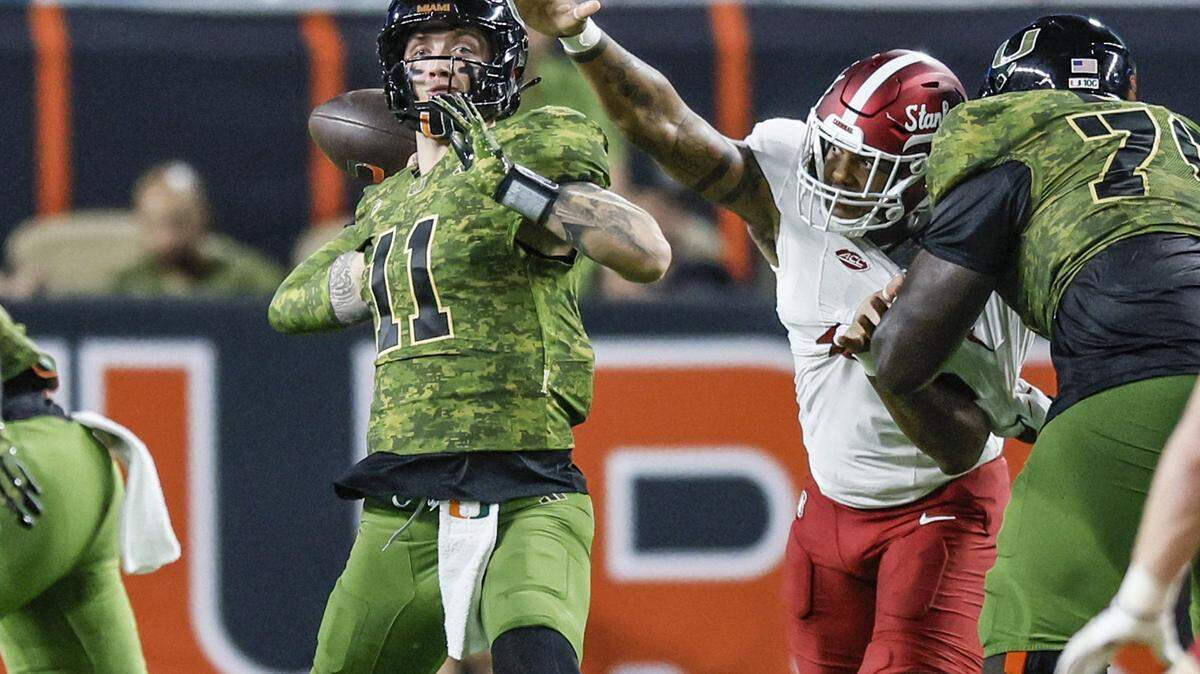 Miami Hurricanes quarterback Carson Beck (11) looks to pass in the first half of the NCAA football game against the Stanford Cardinal at Hard Rock Stadium in Miami Gardens, Florida, on Saturday, October 25, 2025.