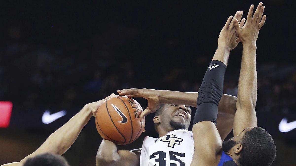 Tulsa forward Jeriah Horne (41) stops UCF forward Collin Smith (35) during the Knights’ two-point win Saturday.