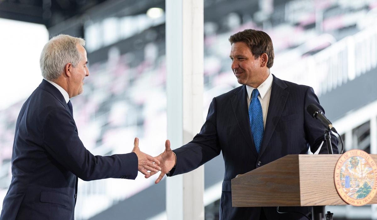 Florida Governor Ron DeSantis shakes hands with Inter Miami Managing Owner Jorge Mas during a press conference at Chase Stadium on Thursday, Aug. 8, 2024, in Fort Lauderdale, Fla. DeSantis announced that the state would give Miami-Dade County $8 million to help with the cost of infrastructure construction as the team prepares to build Miami Freedom Park.