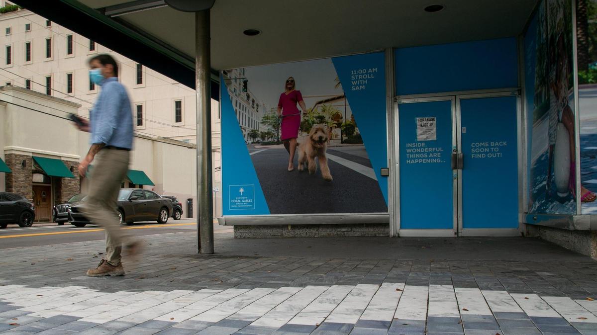 Coral Gables, Florida, November 25, 2020- A pedestrian walks by an empty shop in Miracle Mile.