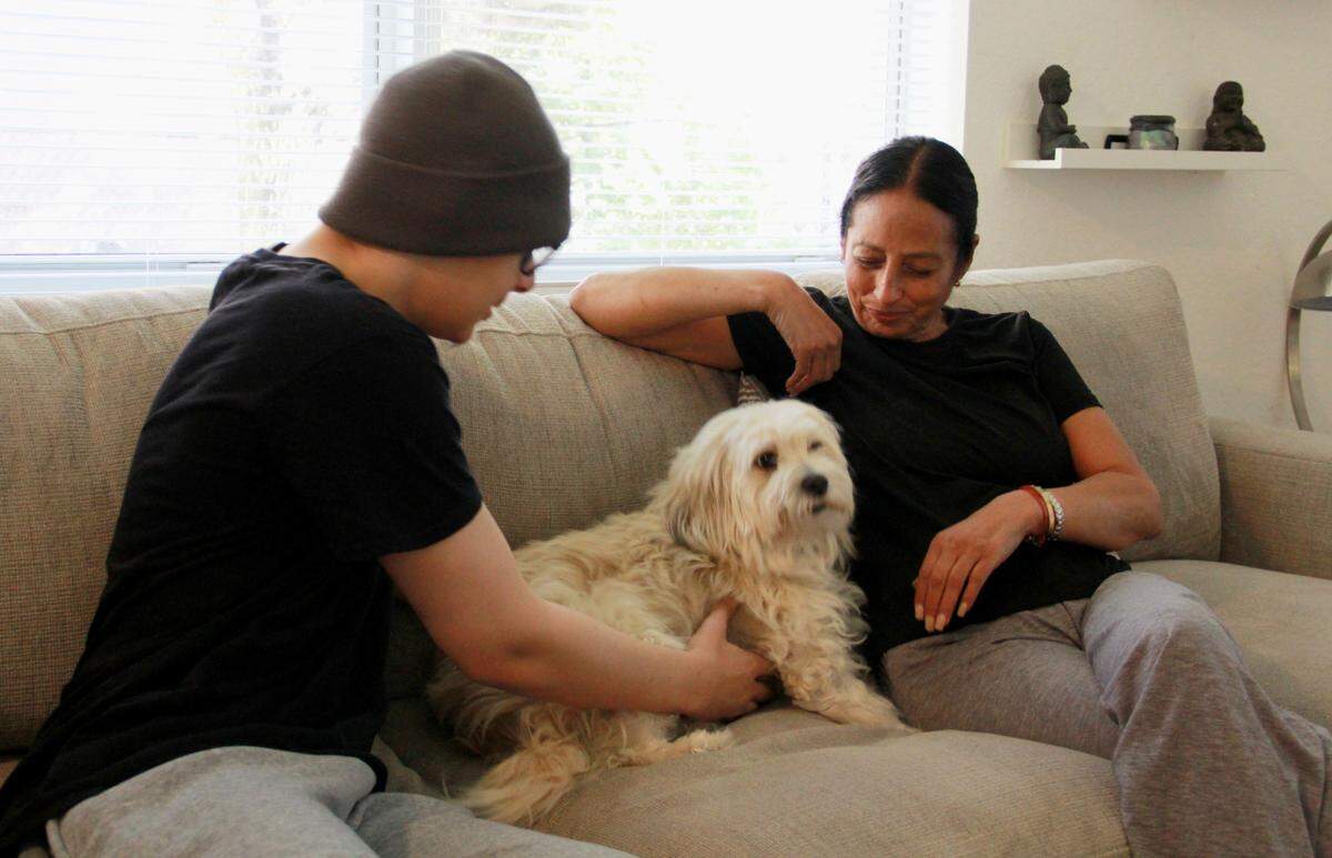 Jordan Gotay, his grandmother, Esperanza Batista, and their loyal family dog, Kenya, find comfort and strength together at home.