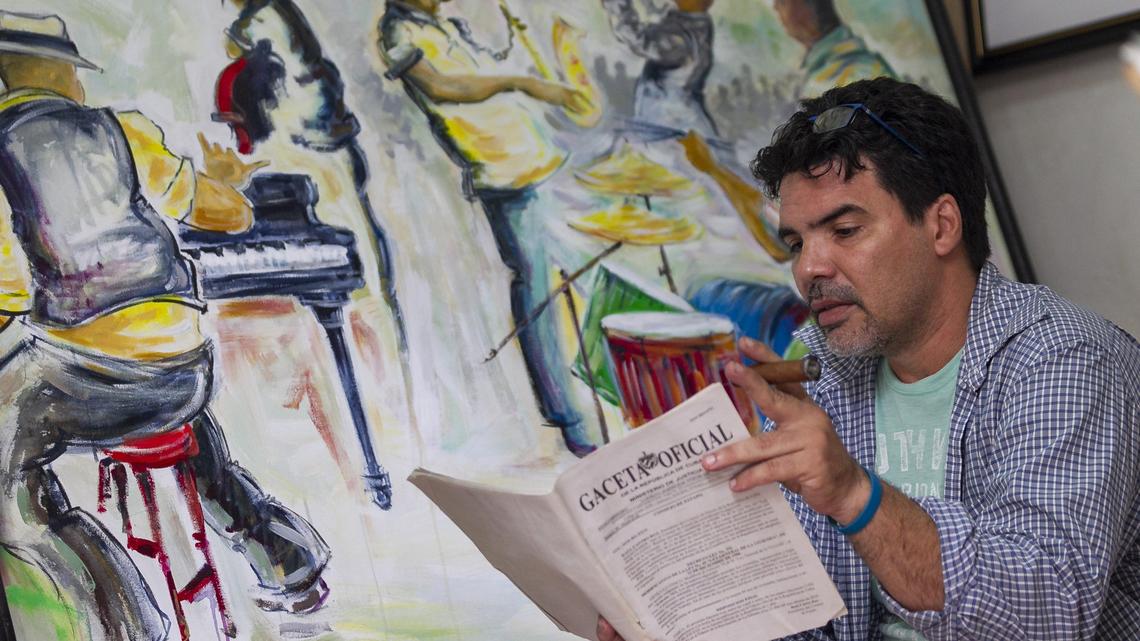 Cuban artist Luis Puerta Batista reads through a copy of Decree Law 349 at his studio in Old Havana. Batista says the law amounts to censorship.