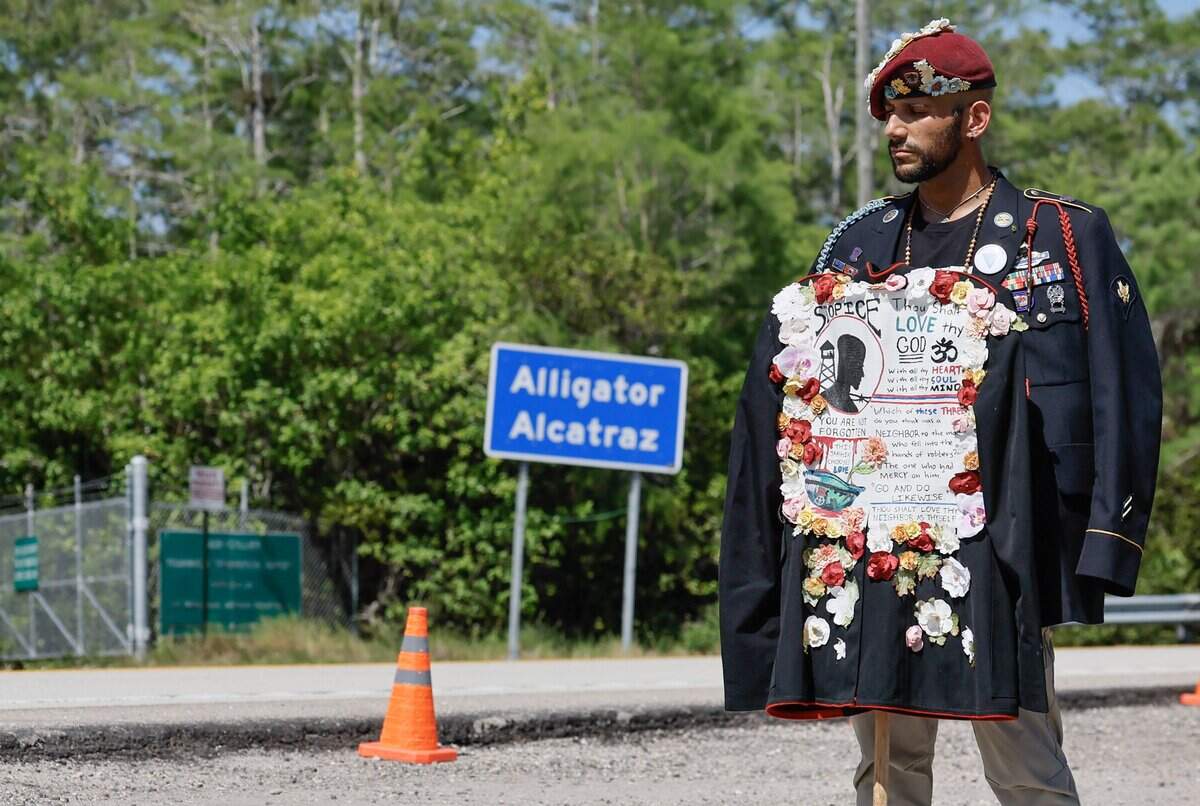 Javier Del Rio, who served in the US Army and Marines, stands in protest during a May Day Rally outside of Alligator Alcatraz located at the Dade-Collier Training and Transition Airport in the Florida Everglades, Ochopee, Florida, on Friday, May 1, 2026.