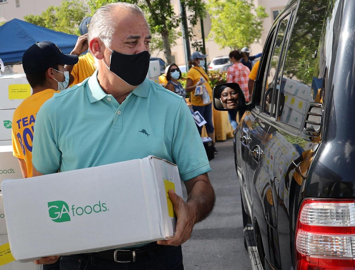 Esteban “Steve” Bovo, a county commissioner running for Miami-Dade mayor, helps in food distribution at St. Monica’s Catholic Church in Miami Gardens, Florida, on Wednesday, June 24, 2020.