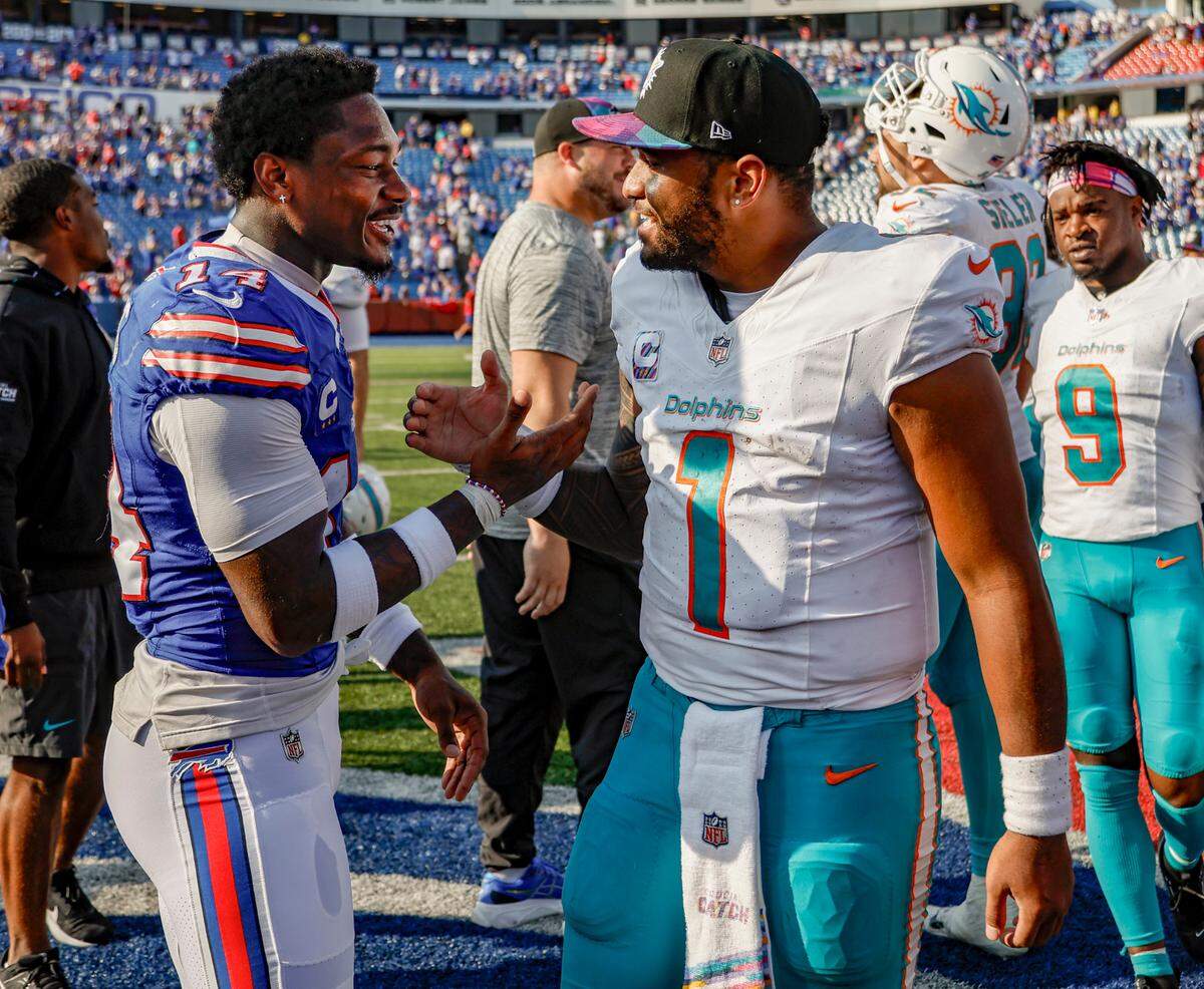 Miami Dolphins quarterback Tua Tagovailoa (1) meets up with Buffalo Bills wide receiver Stefon Diggs (14) at midfield after the game at Highmark Stadium in Orchard Park, NY., on Sunday, October 1, 2023.
