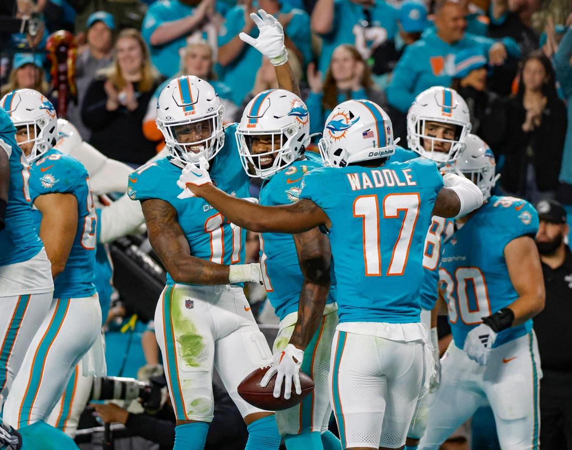 Miami Dolphins running back Raheem Mostert (31) celebrates a fourth quarter touchdown with teammates during the game against the Tennessee Titans at Hard Rock Stadium in Miami Gardens, Florida on Monday, December 11, 2023.