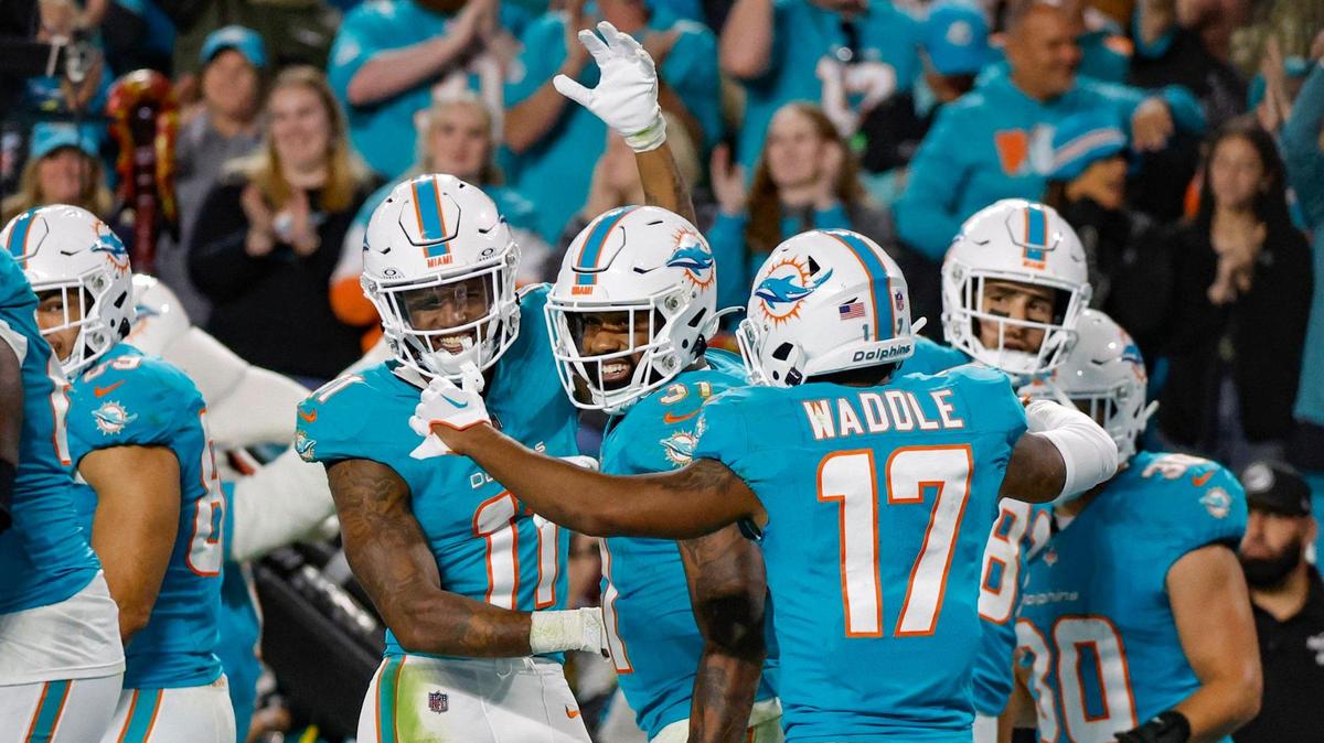 Miami Dolphins running back Raheem Mostert (31) celebrates a fourth quarter touchdown with teammates during the game against the Tennessee Titans at Hard Rock Stadium in Miami Gardens, Florida on Monday, December 11, 2023.
