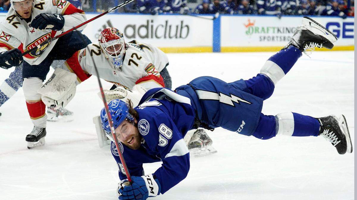 Tampa Bay Lightning left wing Brandon Hagel (38) goes down after crashing into Florida Panthers goaltender Sergei Bobrovsky (72) and defenseman Gustav Forsling (42) during the second period in Game 3 of an NHL hockey second-round playoff series Sunday, May 22, 2022, in Tampa, Fla. (AP Photo/Chris O’Meara)