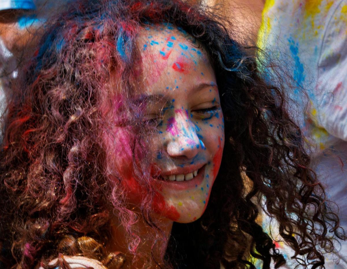 Penelope Beltran, 8, smiles after her mother puts colored powder on her during the celebration of Holi, the Hindu festival of colors, on Sunday, March 16, 2025, at Kendall Indian Hammocks Park in Miami, Fla. The colors are a way of showing affection towards each other.