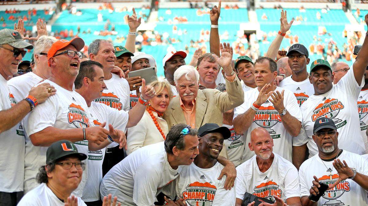 The Miami Hurricanes 1983 National Championship team surrounds then coach Howard Schnellenberger during a ceremony at half time as the University of Miami plays Florida International University Saturday, Sept. 22, 2018, at Hard Rock Stadium in Miami Gardens, Fla.