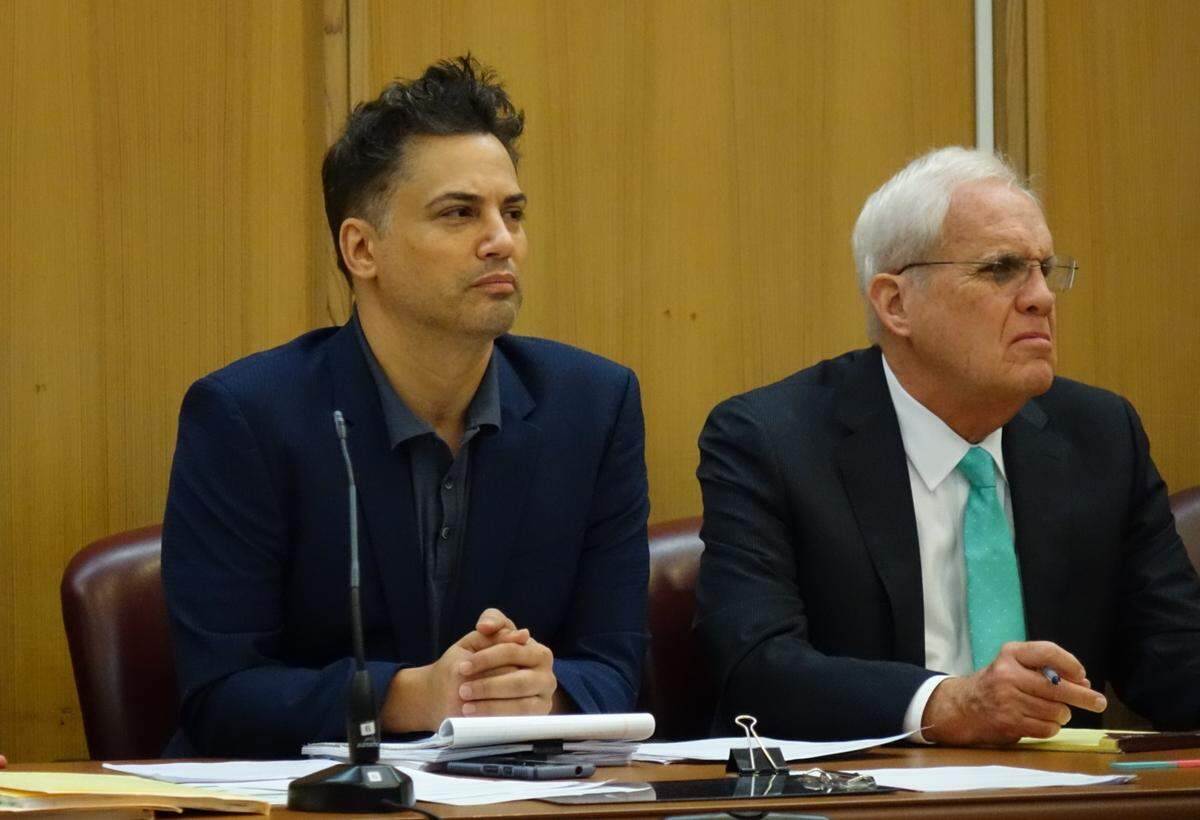 Real-estate agent Kevin Tomlinson, left, at the defendant's table with defense lawyer Richard Houlihan. He is accused of extorting rival Realtors on Miami Beach.