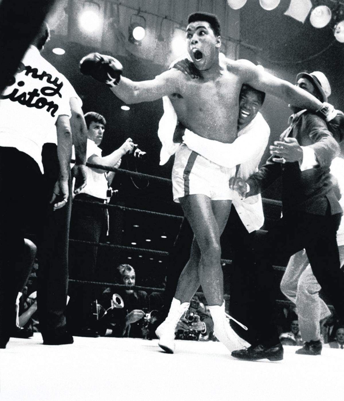 Muhammad Ali is jubilant after knocking out Sonny Liston in their world heavyweight championship bout at the Miami Beach Convention Hall in 1964.