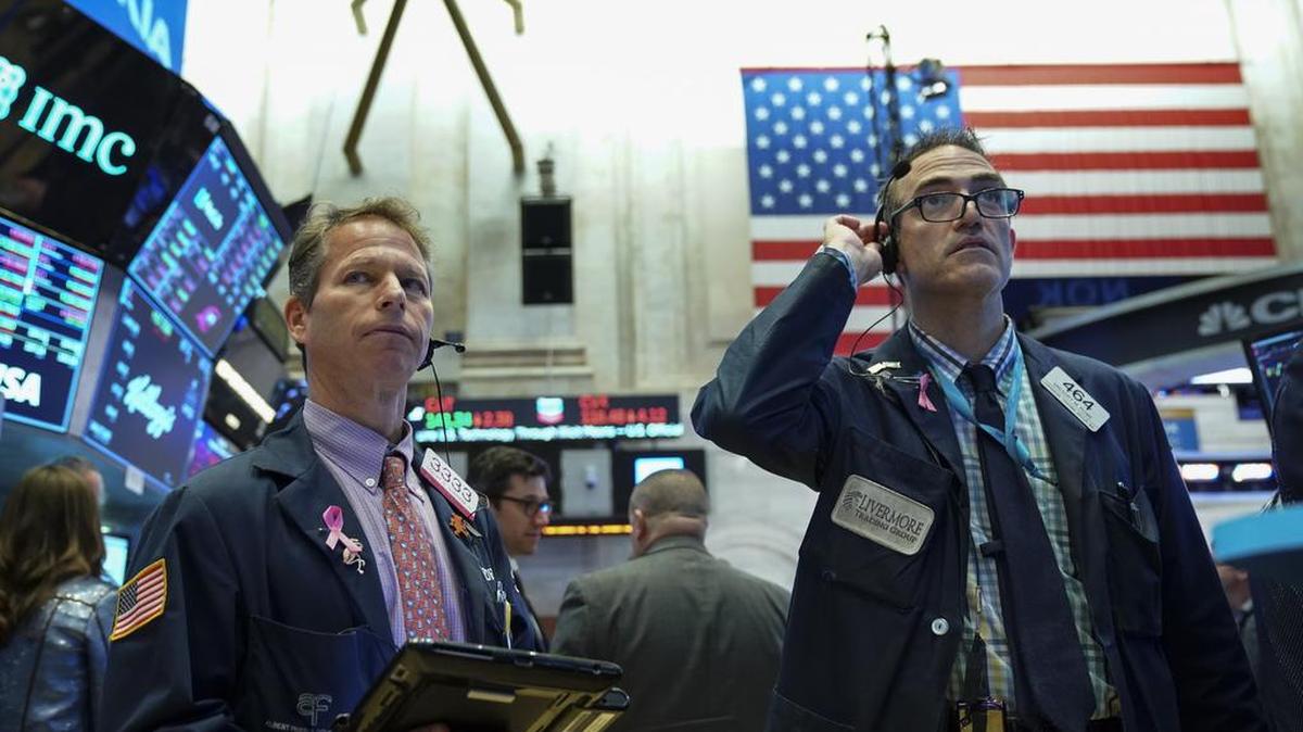 Traders and financial professionals work ahead of the closing bell on the floor of the New York Stock Exchange on Oct. 11 in New York. The Dow closed over 500 points down on Thursday, bringing 2-day losses to more than 1,300 points.