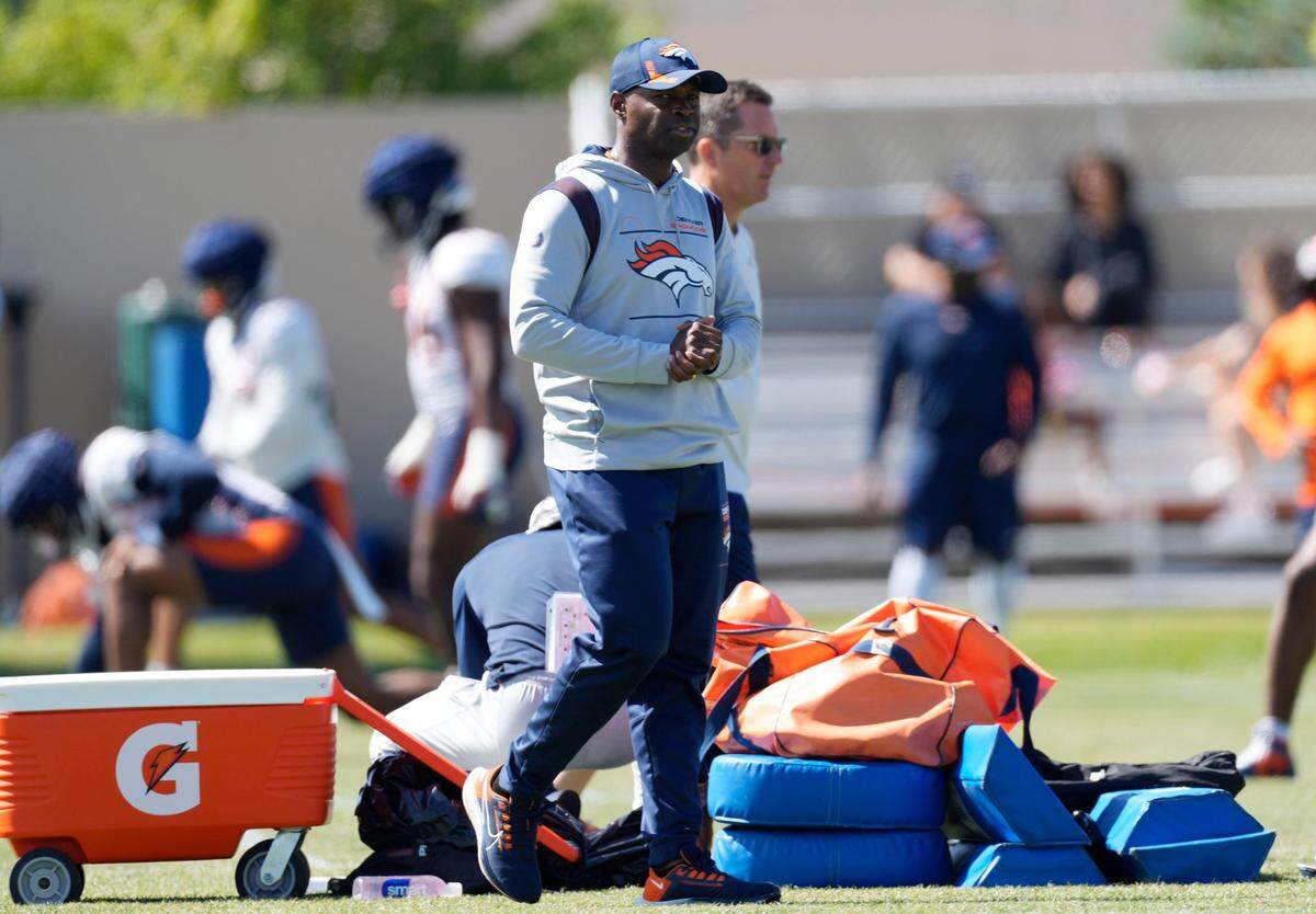 FILE - Denver Broncos defensive coordinator Ejiro Evero takes part in drills during an NFL football training camp session at the team’s headquarters on Aug. 8, 2022, in Centennial, Colo. Evero elected to pass on taking the interim head coaching job after his good friend Nathaniel Hackett was fired on Monday, Dec. 26, 2022. (AP Photo/David Zalubowski, File)