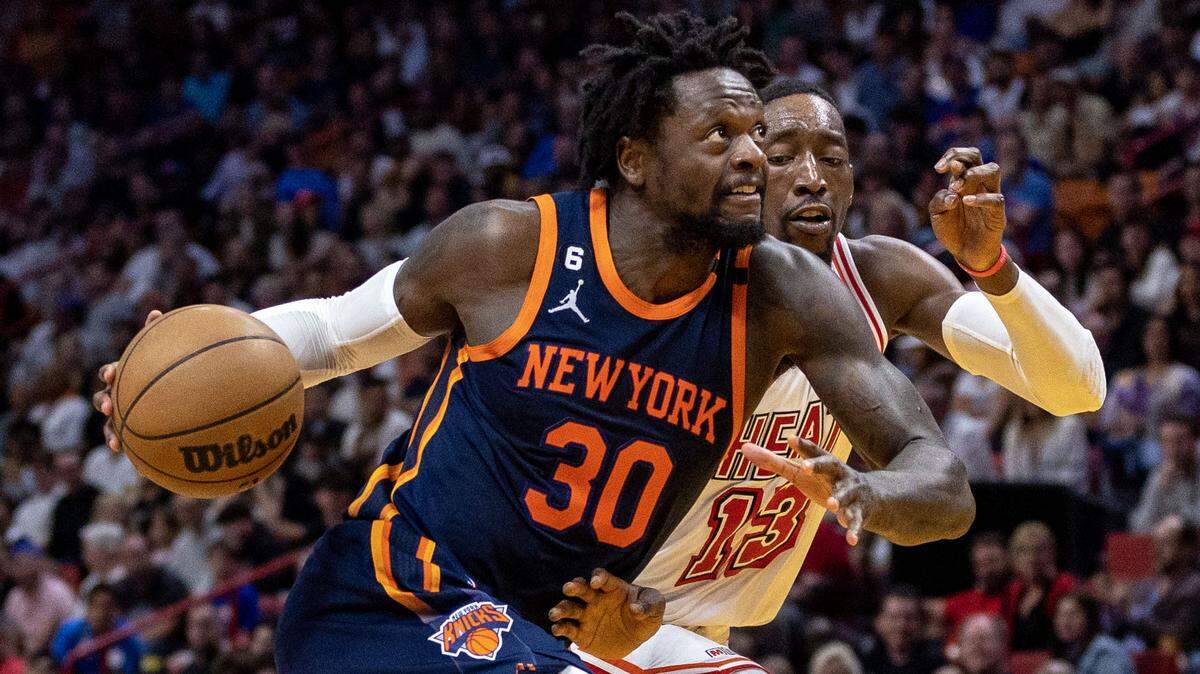 New York Knicks forward Julius Randle (30) drives on Miami Heat center Bam Adebayo (13) during the fourth quarter of an NBA game at Miami-Dade Arena in Downtown Miami, Florida, on Wednesday, March 22, 2023.