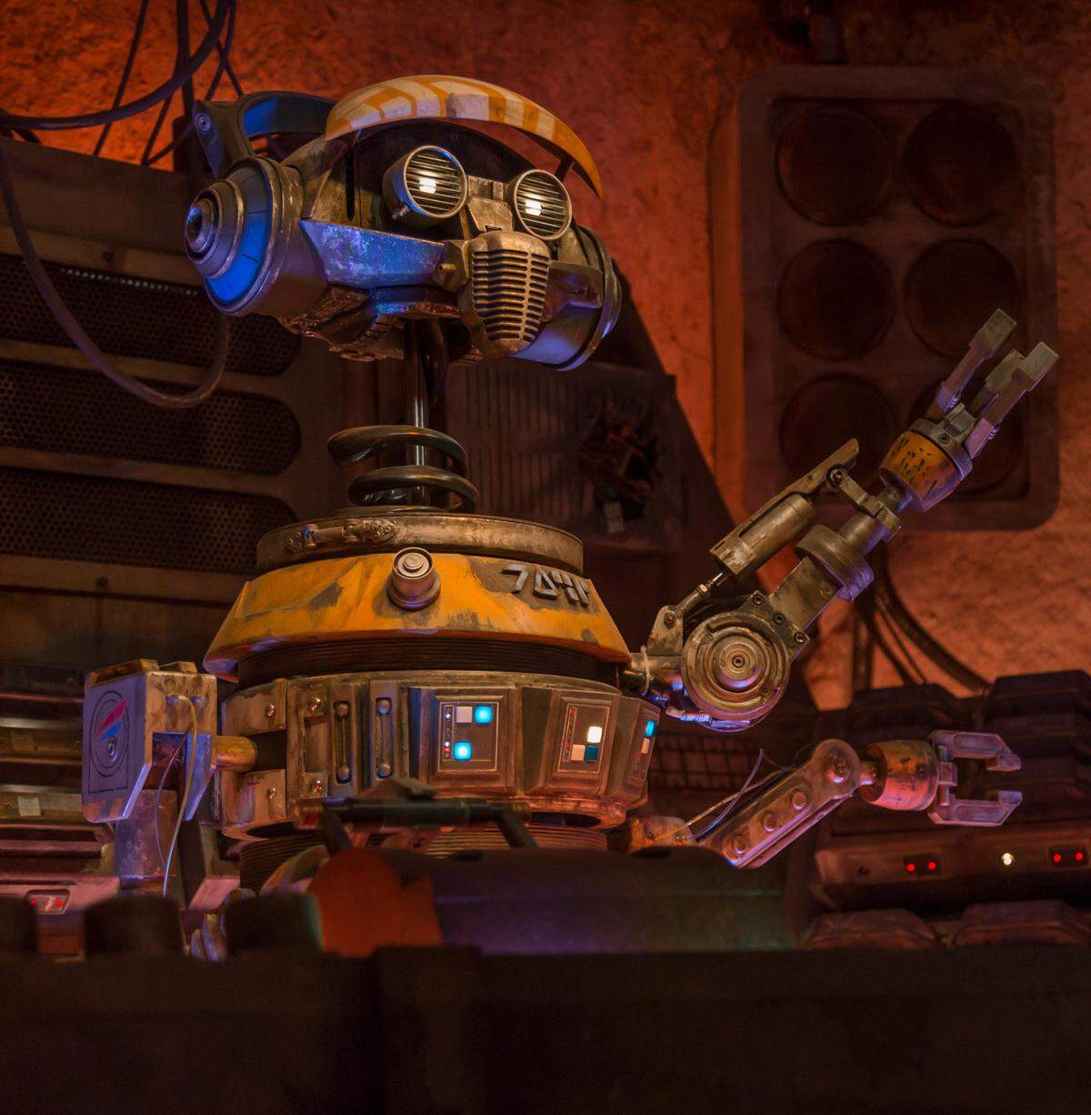 Rex, the not-so-good pilot droid from Star Tours, shows up as a DJ at Oga’s Cantina on Batuu.