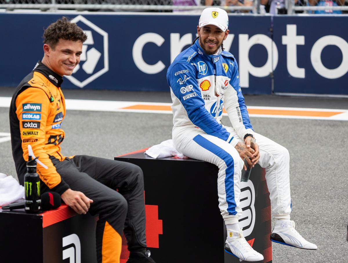 McLaren drivers Lando Norris of Britain talks with Scuderia Ferrari driver Lewis Hamilton of Britain after placing first in their Sprint race on the second day of the Formula One Miami Grand Prix at the Miami International Autodrome on Saturday, May 3, 2025, in Miami Gardens, Fla.