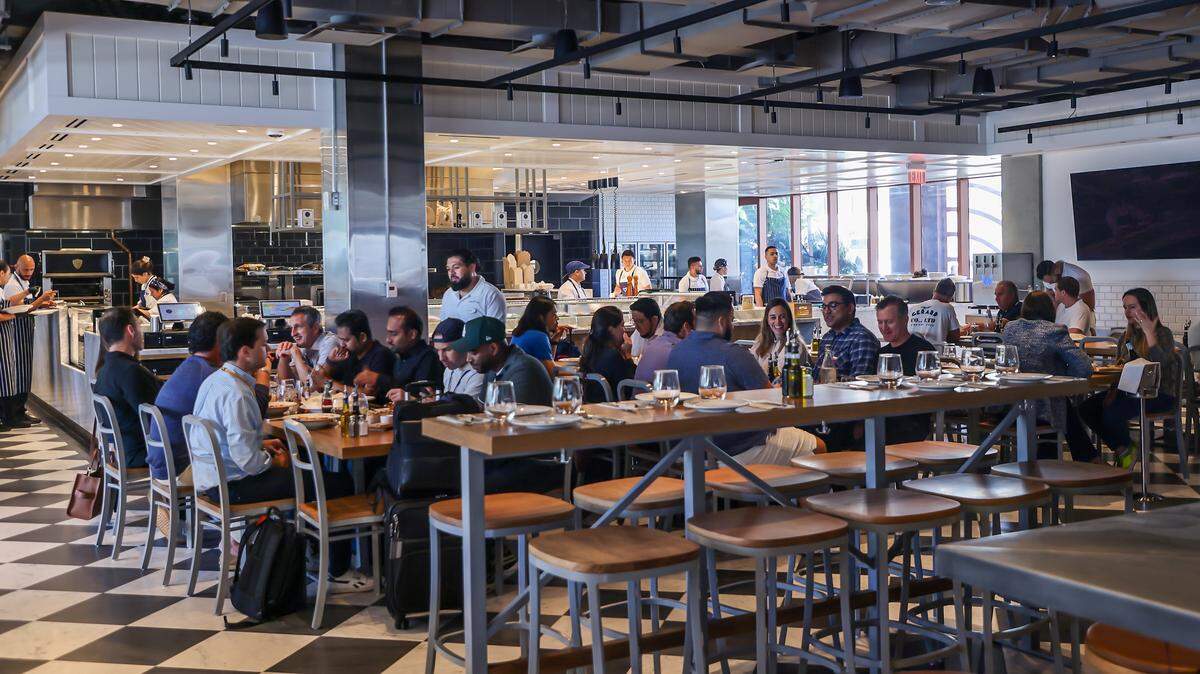 CasaTua Cucina diners enjoy the spacious, upscale Italian food hall and the restaurant features an open layout with high ceilings, communal tables, and multiple dedicated dining areas-making it suitable for both intimate dinners and larger group gatherings. in Miami's Wynwood Art District on Thursday, April 16, 2026.