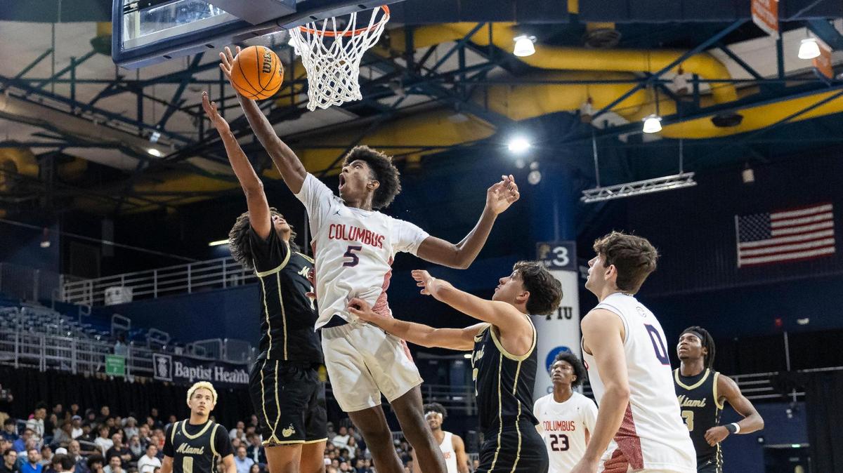 Columbus Explorers Jaxon Richardson (5) tries to score as Miami Stingarees Joseph Jean (1) defends in the second half of their Region 4-7A championship basketball game final at the Ocean Bank Convocation Center on Thursday, Feb. 20, 2025, in Miami, Fla.
