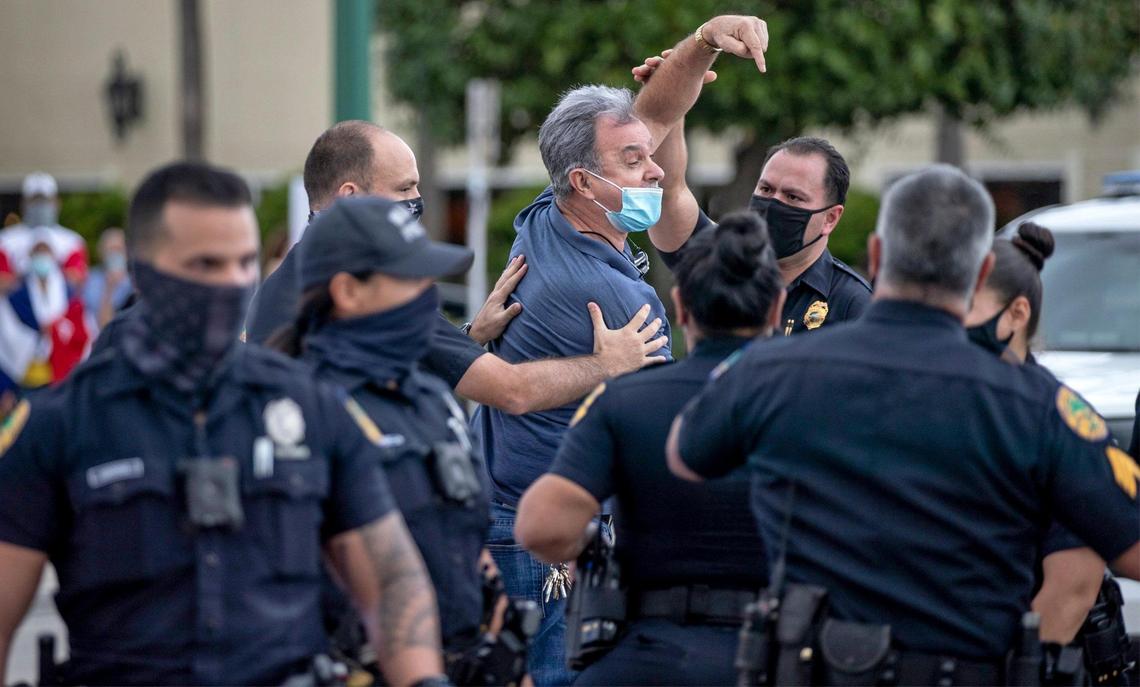 Ramon Saul Sanchez appears to be detained but then released by Miami Police during rally at Versailles Restaurant in Miami in support of Cuban artists arrested by the Cuban government on Saturday, November 28, 2020.