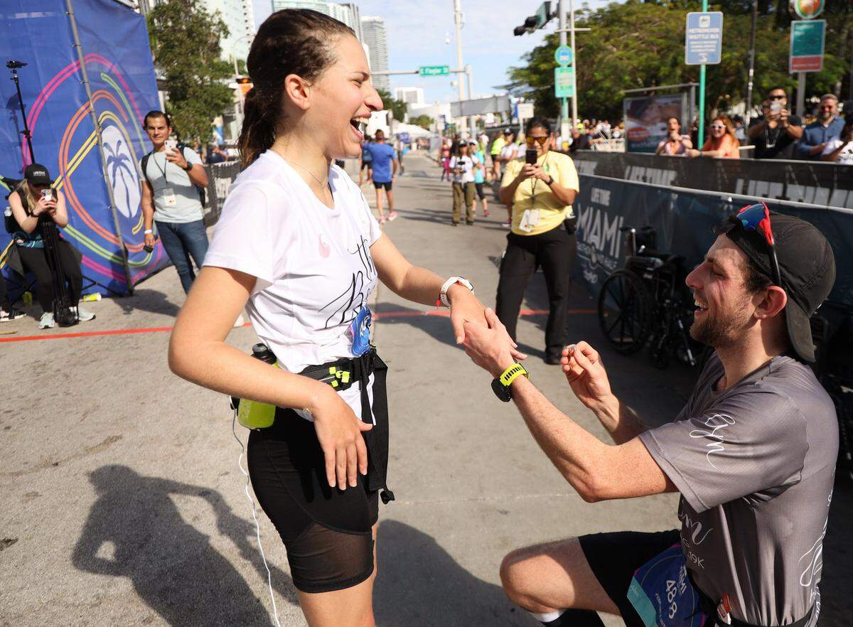 Millie Bistre breaks into joyous laughter after accepting Alan Sarfatis, right, marriage proposal at the finish line of the 18th annual Life Time Miami Marathon and Half Marathon where runners took off in the dark at 6 a.m. Sunday, February 9, 2020 in front of AmericanAirlines Arena and finished on Biscayne Boulevard near Bayfront Park. There were more than 20,000 combined runners registered for the marathon and half marathon.