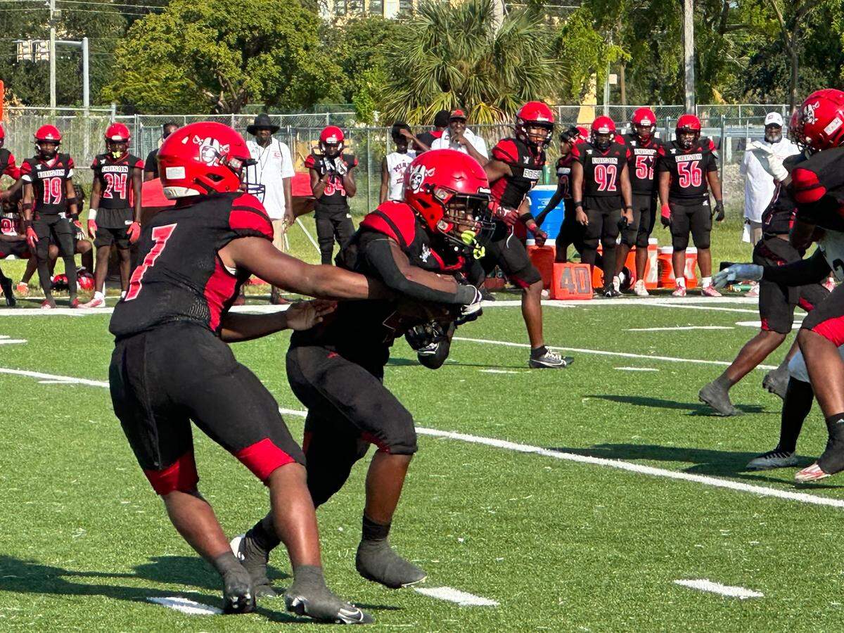 Miami Edison running back Sterling Joseph takes a handoff from quarterback Kelvin Murray Jr. during Thursday afternoon’s home game against North Miami. Joseph ran for 207 yards and two touchdowns in a Red Raiders win.