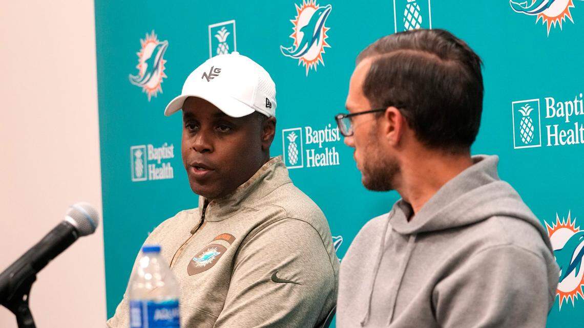 Miami Dolphins general manager Chris Grier, left, and head coach Mike McDaniel, right, respond to questions during a news conference at the NFL football team’s training facility, Monday, Jan. 16, 2023, in Miami Gardens, Fla. (AP Photo/Lynne Sladky)