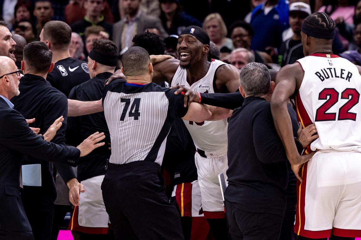 Miami Heat center Bam Adebayo (13) is held back by referee Curtis Blair (74) after a foul against New Orleans Pelicans forward Zion Williamson (1) during the second half at Smoothie King Center.
