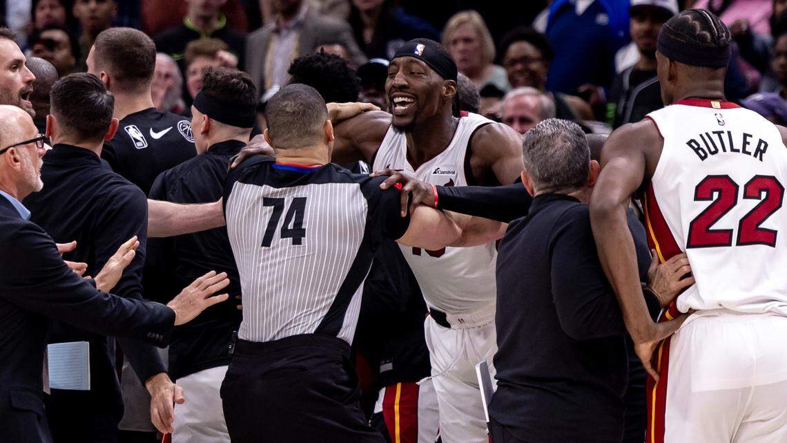 Miami Heat center Bam Adebayo (13) is held back by referee Curtis Blair (74) after a foul against New Orleans Pelicans forward Zion Williamson (1) during the second half at Smoothie King Center.