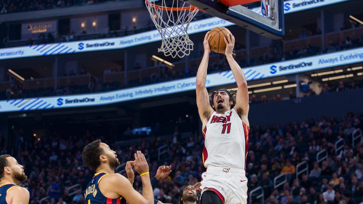 Miami Heat forward Jaime Jaquez Jr. (11) shoots as Golden State Warriors forward Kyle Anderson (1) and guard Buddy Hield (7) defend during the first quarter at Chase Center.