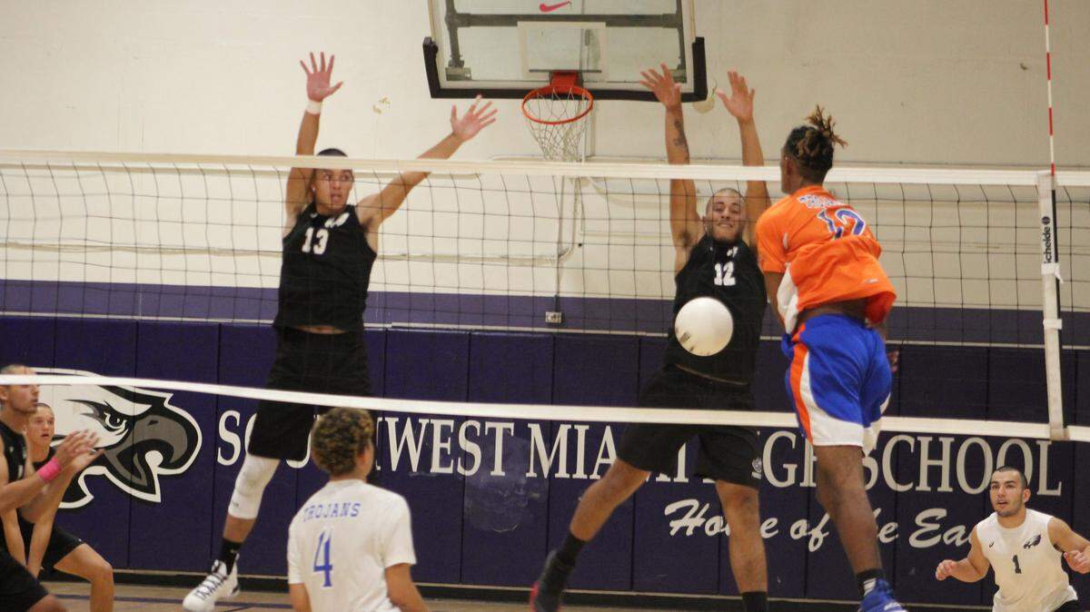 Soutwest’s Eliezer Gonzalez (13) and Daniel Pupiro go up to block a shot by Hialeah-Miami Lakes’ Kevin Mena during Friday night’s regional final at Southwest High School. The Eagles won the match in straight sets to advance to state for the second straight year.