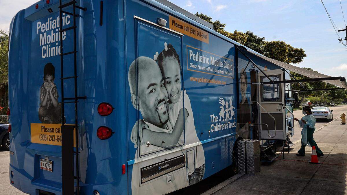 The UHealth mobile clinic parks outside Arch Creek Elementary in North Miami to provide vaccine shots to children as part of the free vaccine drives throughout Miami-Dade County in this May 2020 file photo.