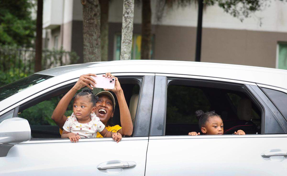 A woman screams “Souls to the Polls!” out of her car window during the Souls to the Polls march to the African American Research Library and Cultural Center on Sunday, Aug. 18, 2024, in Fort Lauderdale, Fla.