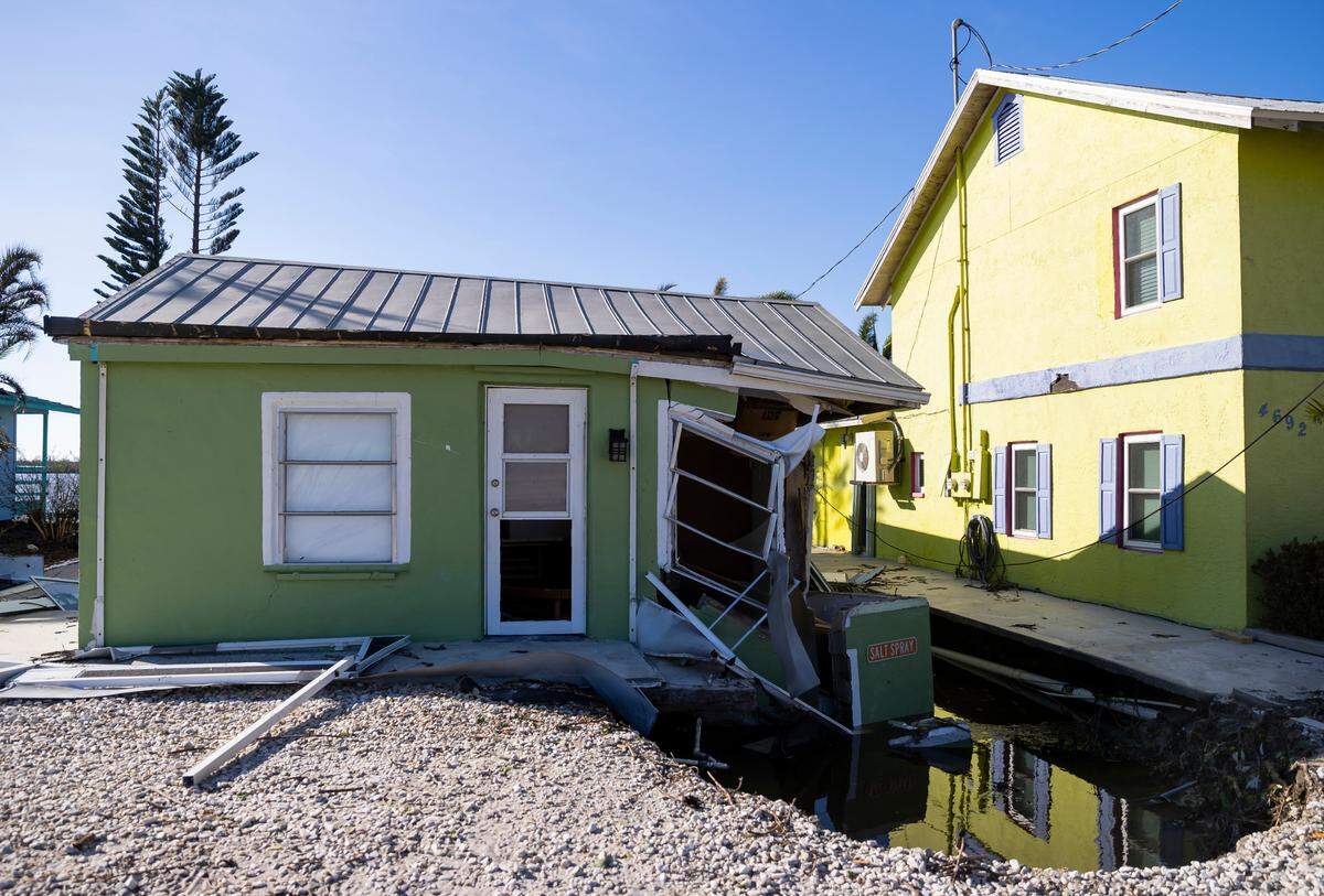 A damaged property is seen near a broken section of Pine Island Road on Thursday, Sept. 29, 2022, in Matlacha, Fla. Hurricane Ian made landfall on the coast of South West Florida as a category 4 storm Tuesday afternoon leaving areas affected with flooded streets, downed trees and scattered debris.