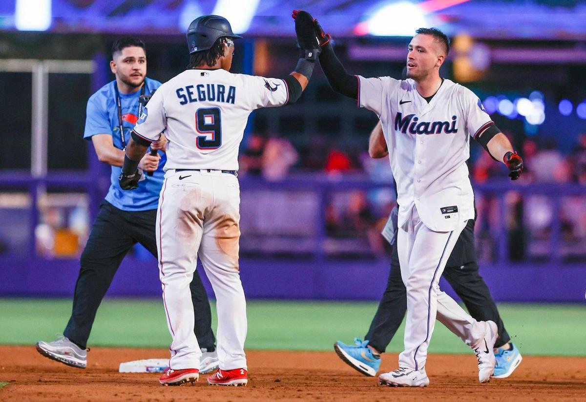 Miami Marlins catcher Nick Fortes (4) celebrates on the field with third baseman Jean Segura (9) after Fortes singles on a ground ball and Segura scores in the ninth inning to win the game against the San Diego Padres at loanDepot Park in Miami on Wednesday, May 31, 2023.