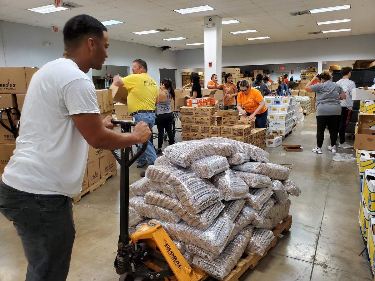 Volunteers sorting food at Feeding South Florida’s warehouse in Pembroke Park. The nonprofit has launched a COVID-19 Response Fund to help those in need.
