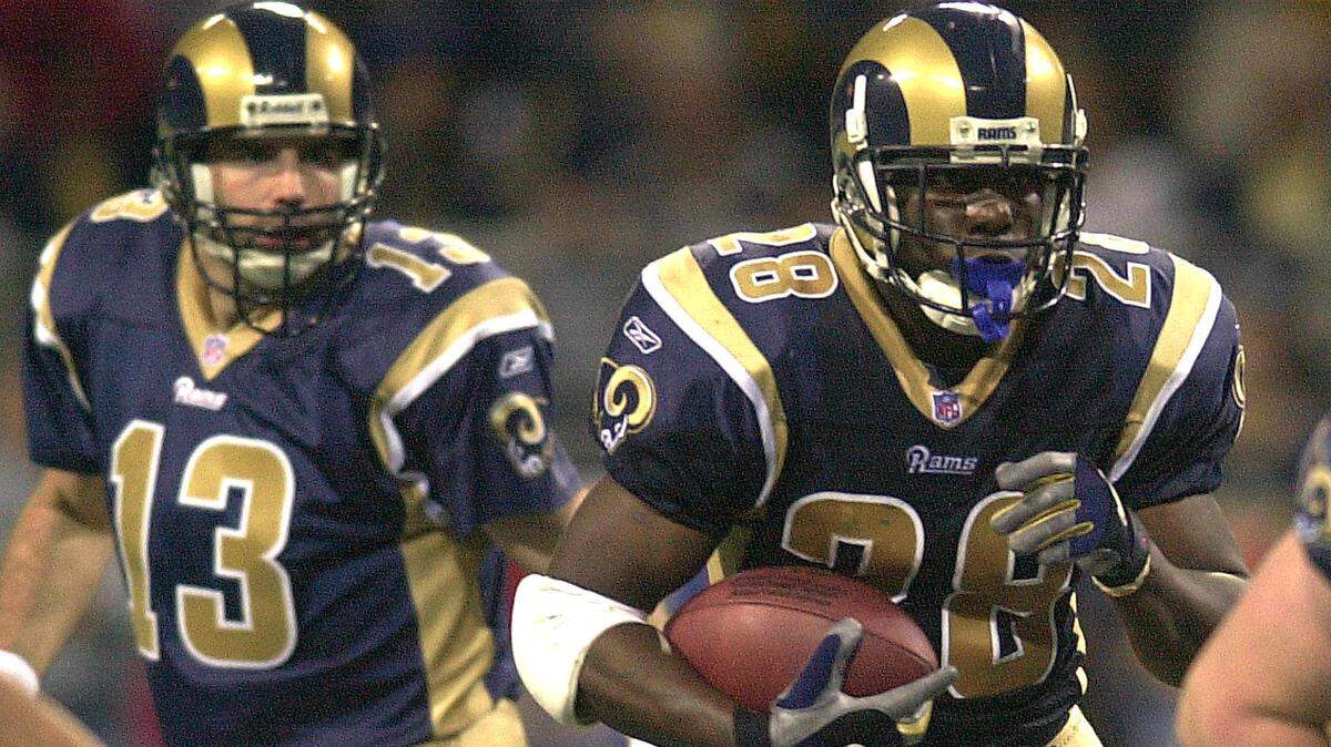 The two most important players of the Rams’ Greatest Show on Turf era, quarterback Kurt Warner and running back Marshall Faulk in the 2001 NFC Championship Game win over Philadelphia. Warner won the NFL MVP award in 1999 and 2001. Faulk won it in 2000.