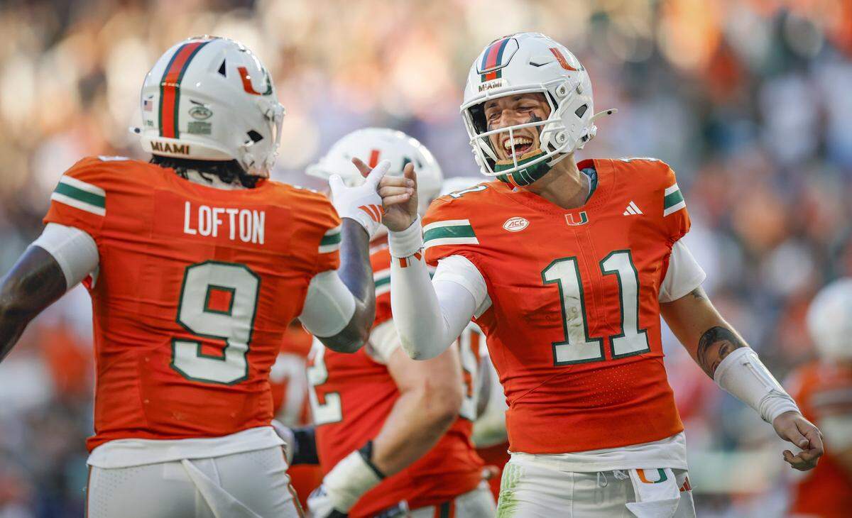 Miami Hurricanes tight end Elija Lofton (9) and Miami Hurricanes quarterback Carson Beck (11) celebrate after Beck scores in the first half during an NCAA football game against Syracuse Orange at Hard Rock Stadium in Miami Gardens, Florida on Saturday, November 8, 2025.