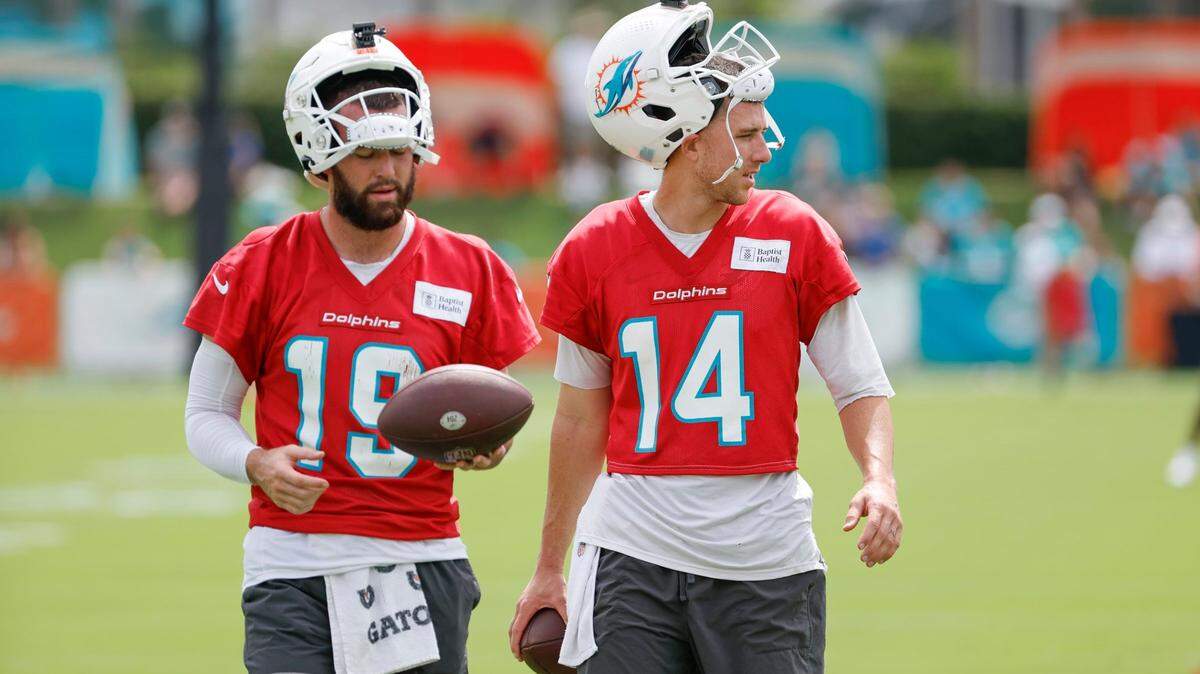 Miami Dolphins quarterback Skylar Thompson and quarterback Mike White (14) prepare for a passing drill during practice at the Miami Dolphins training facility in Miami Gardens, FL, on Thursday, August 1, 2024.