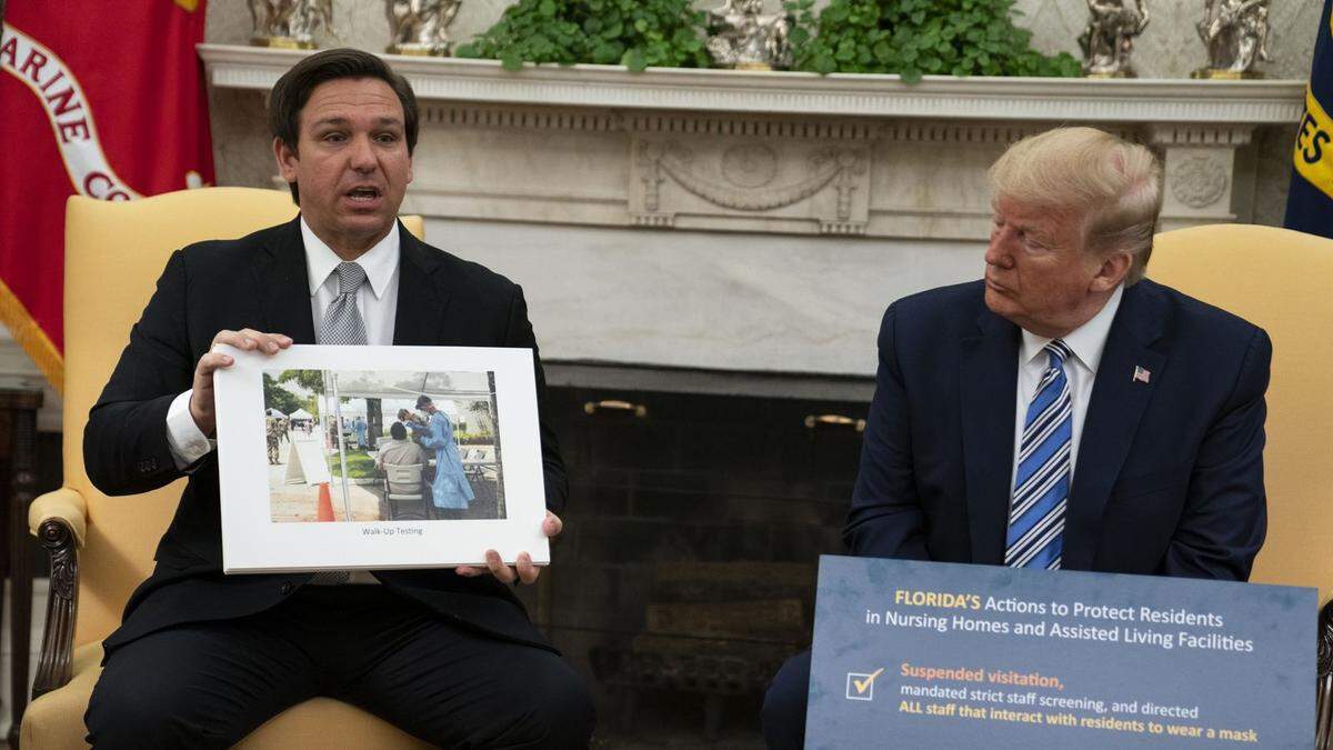 Florida’s Gov. DeSantis sits with President Trump at the White House before later reopening most of the state after weeks of coronavirus lockdown.