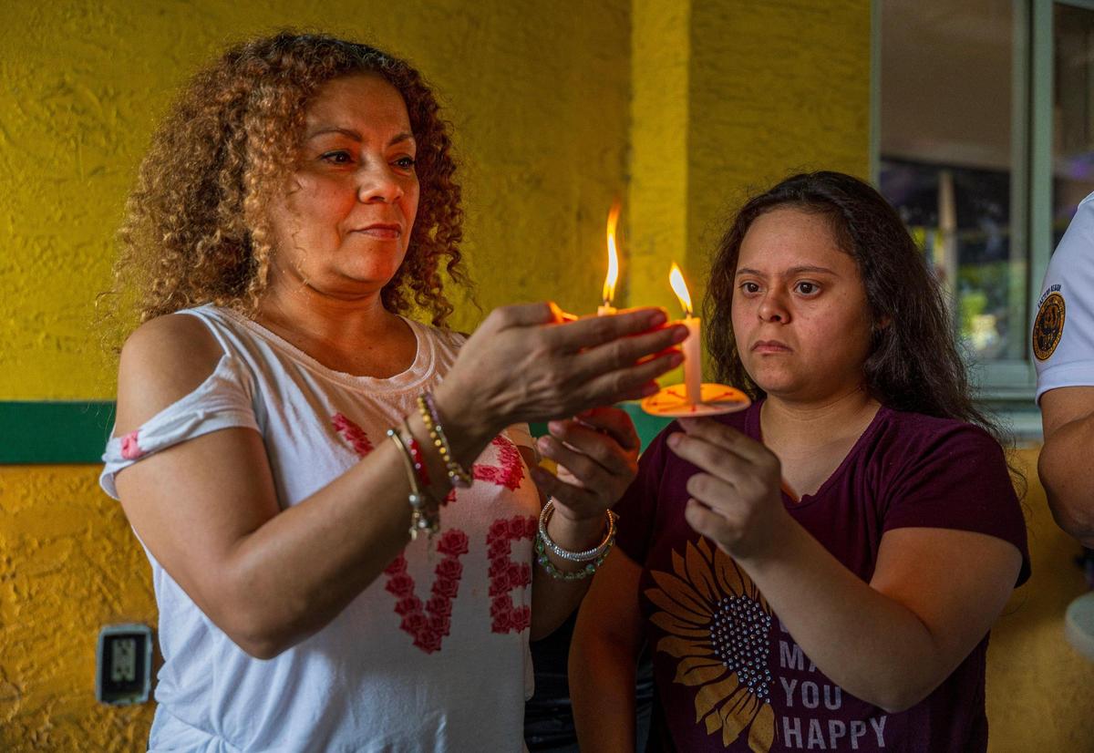 Honduran-Americans Ana Santos (left) and Angie Carballo attended a vigil in Doral Thursday night in support of extending Temporary Protected Status for Venezuelans.