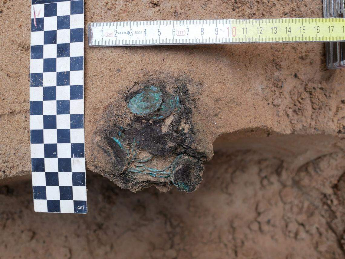 The coins have a green patina because they are made of copper and silver, according to experts.