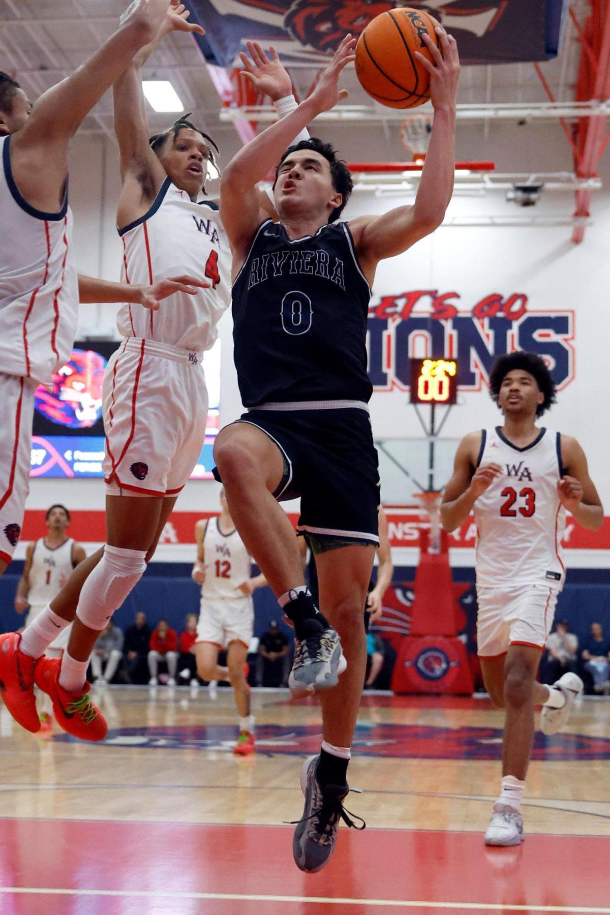 Riviera Prep Bulldogs guard Myles Fuentes (0) drives to the basket as Westminster Academy Lions defend during boy’s basketball FHSAA Regional Finals at Westminster Academy School in Fort Lauderdale, Fl on Friday, February 23, 2024.