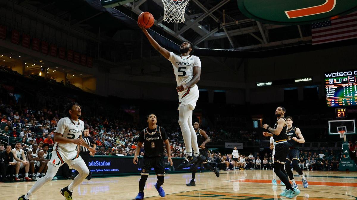 Miami Hurricanes guard Wooga Poplar (5) drives to the basket over La Salle Explorers defenders in the second half during an NCAA basketball game at the Watsco Center in Coral Gables, Florida on Saturday, December 16, 2023.