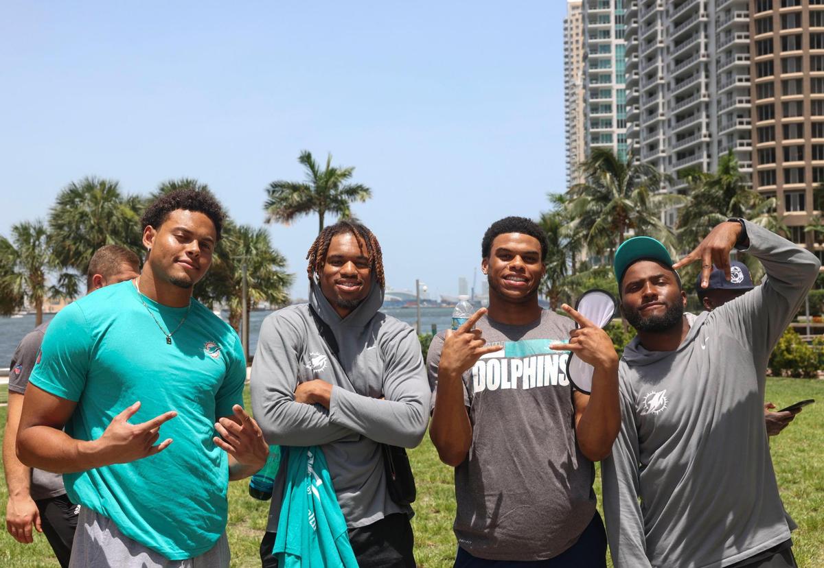 Cameron Goode, left, and Erick Ezukanma, second from left, signed members of the Miami Dolphins rookie class, left, pose for a photo with two others during a historic walking tour of Downtown Miami with local community groups on Wednesday, June 15, 2022, beginning with tour leaders at the History Miami Museum.