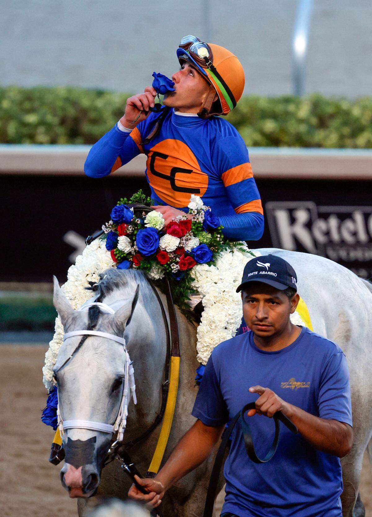 Jockey Irad Ortiz, Jr., riding White Abarrio #4, kisses a flower after winning the 9th Running of the Pegasus World Cup Invitational at Gulfstream Park in Hallandale Beach, Florida on Saturday, January 25, 2025. 