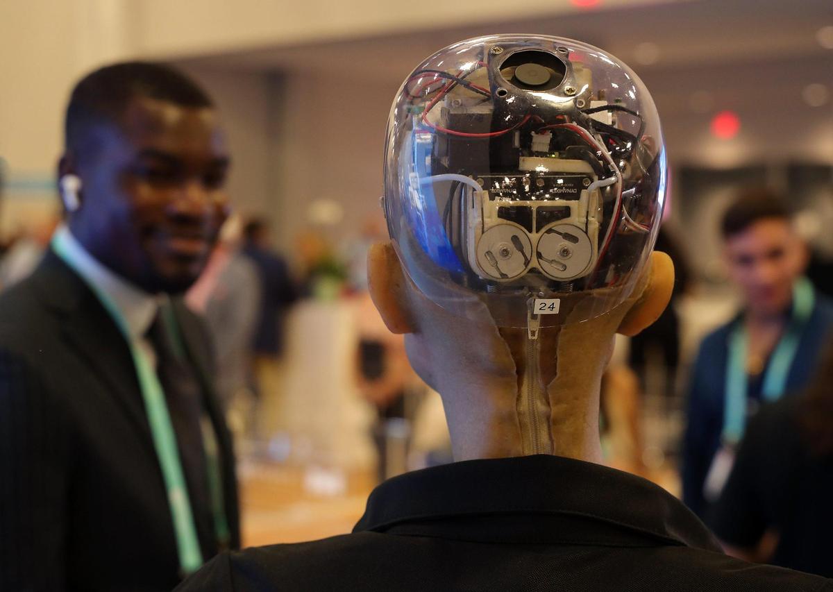 Detail shot of the back of ‘Sophia’ revealing her inner workings as visitors look with amazement at Miami-Dade County’s exhibit at eMerge Americas 2022, a two-day technology conference at the Miami Beach Convention Center.
