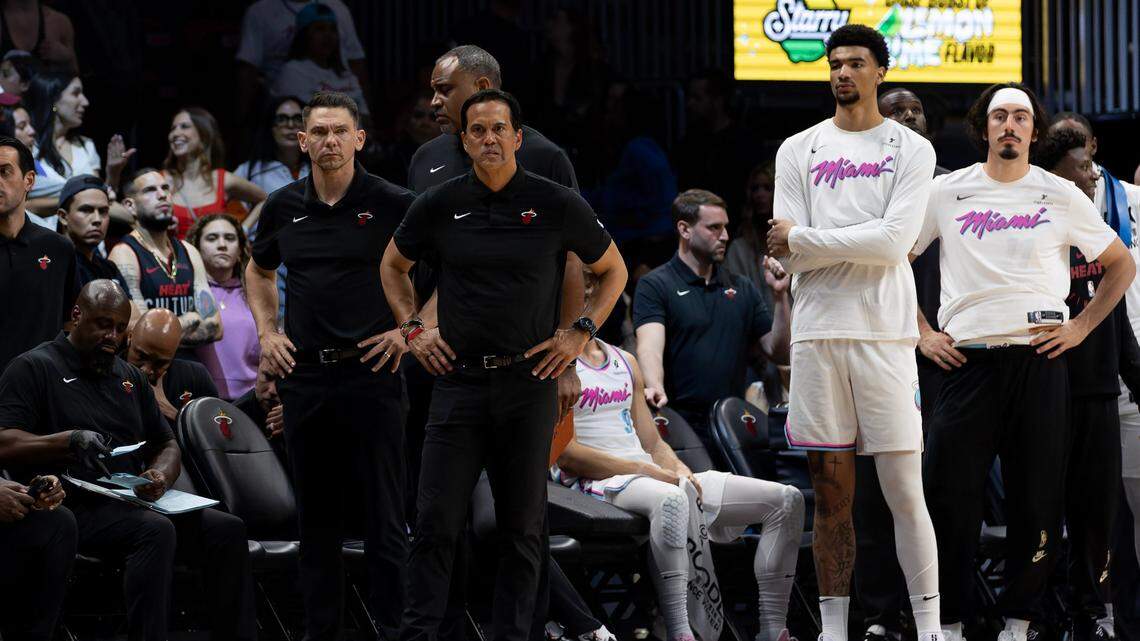 Miami Heat head coach Erik Spoelstra and assistant coach Chris Quinn look from the bench during overtime against the Milwaukee Bucks at Kaseya Center in Miami on April 5, 2025.