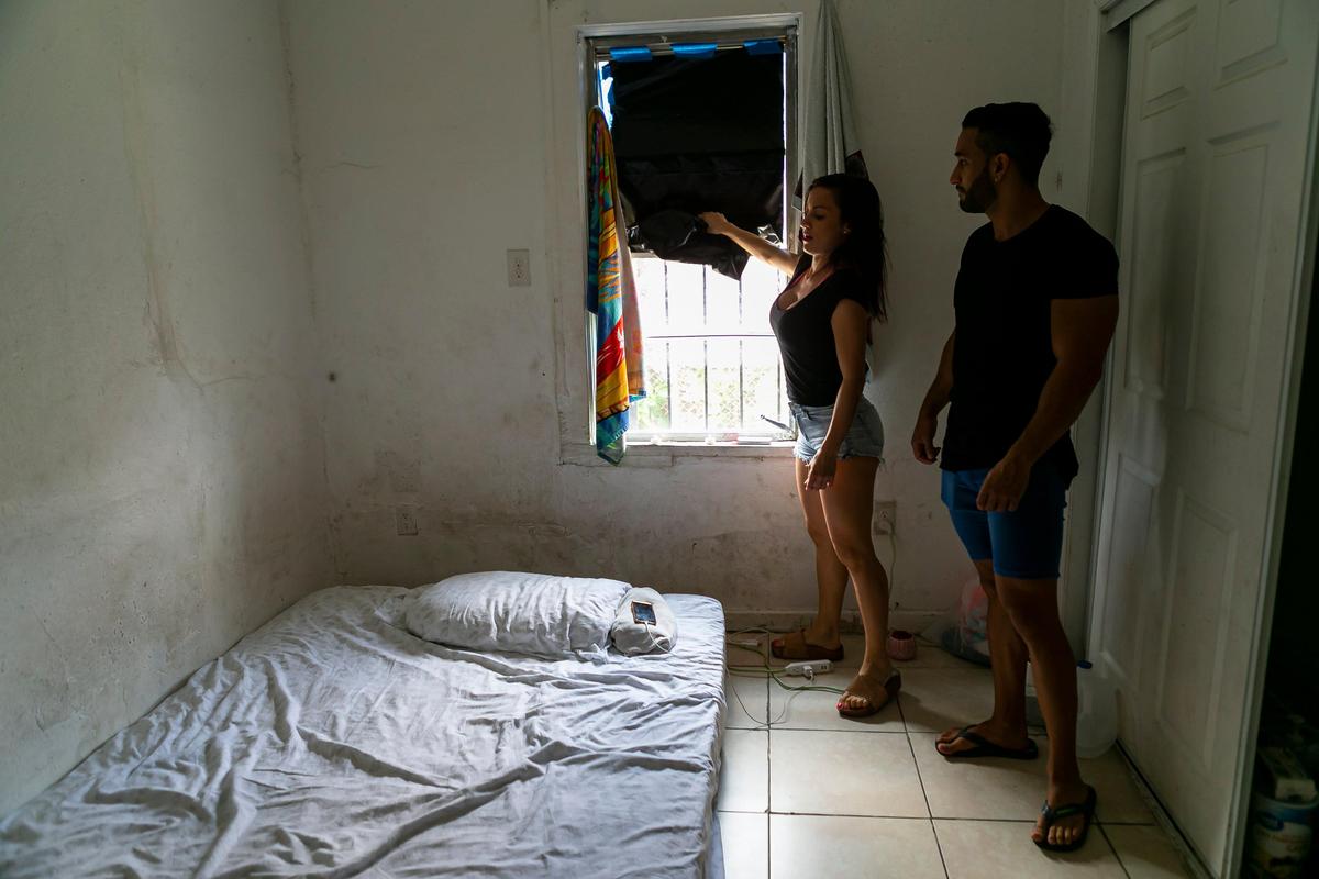 Noelia Perales, 34, and Guillermo Hernandez, 29, Argentinean tourists, are living in an abandoned home in Liberty City after their flights home were canceled due to the coronavirus pandemic. As they wait for a way back home, the group is sleeping on mattresses they found in the trash, and inside an abandoned house infested with roaches, mice and other insects.